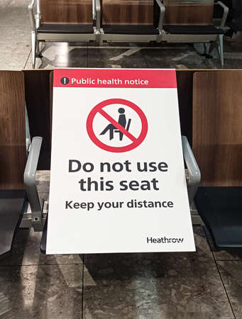 London, England, 15 March 2021. Departures at Heathrow International Airport with side signs warning passengers to keep their distance due to the COVID-19 coronavirusのeditorial素材