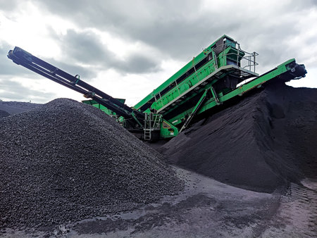 A loader harvester for loading bulk cargo drives onto a pile of granite at the port quay. Mechanized...
