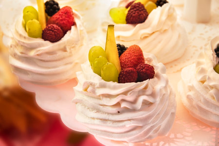 Pastries, preparation and sale of delicious cakes. Australian and New Zealand meringue dessert Pavlova with cream, meringue and fresh fruit. Delicious cake made from natural fresh products.の写真素材