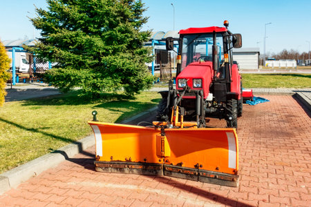 Tractor grader Belarus for road works, sanding and cleaning the road in the parking lot. Tractor for...