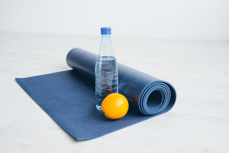 Water bottle, orange, and yoga Mat. Health concept.The toning.の写真素材