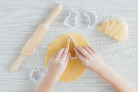 The child prepares homemade Christmas cookies. Hands. Selective focus.の写真素材