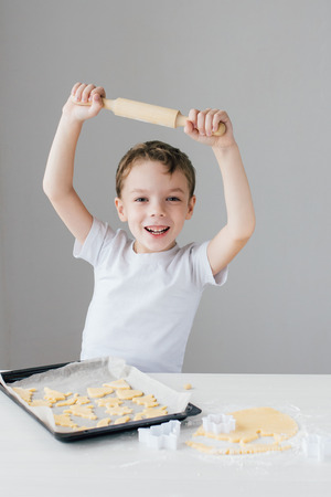 The child prepares homemade Christmas cookies. Selective focus.の写真素材
