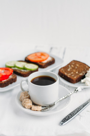 Wholesome Breakfast with vegetarian sandwiches and coffee on white table. Selective focus.の写真素材