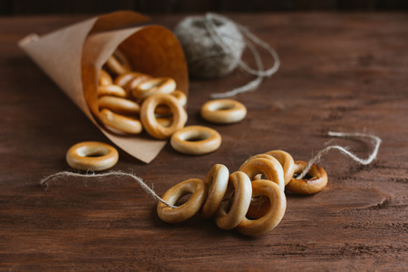 Drying bagels in a paper bag on a brown table. Selective focus. Toning.の写真素材