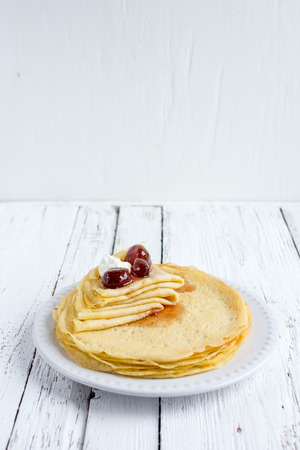 Fried thin pancakes with strawberry jam - traditional Russian dish. Selective focus.の写真素材