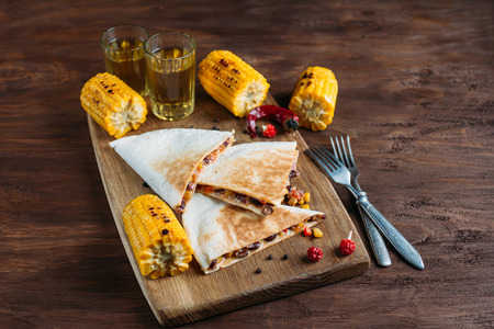 Mexican vegetarian quesadilla with cheese on a dark backgroundの写真素材