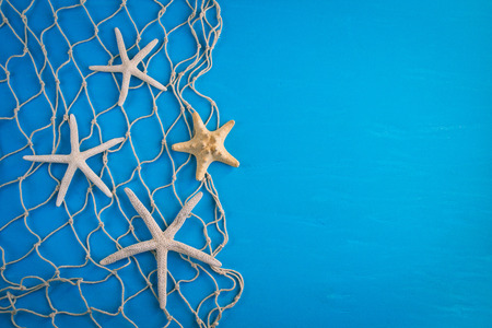 Wooden blue background in marine style. Starfish, net.の写真素材