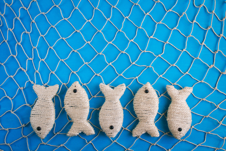 Wooden blue background in marine style. Net, fish.の写真素材
