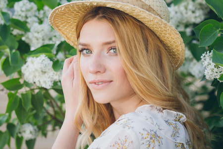 Blond woman with lilac flowers in the springの写真素材