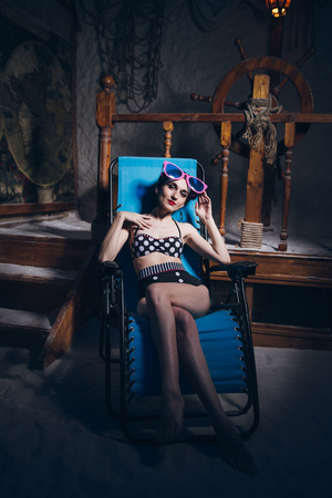 Young beautiful woman in salt room in a bathing suit. The marine theme. Toning.の写真素材