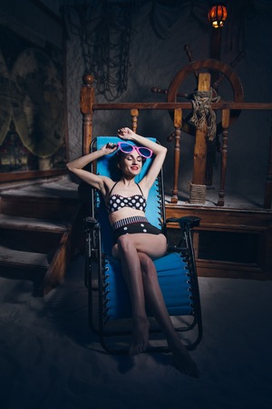 Young beautiful woman in salt room in a bathing suit. The marine theme. Toning.の写真素材