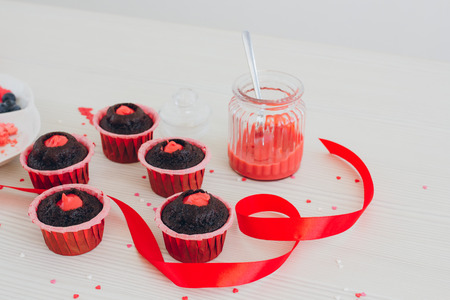 Young girl prepares cupcakes. Add cream filling. The concept of home cooking. Selective focus. Toning.の写真素材