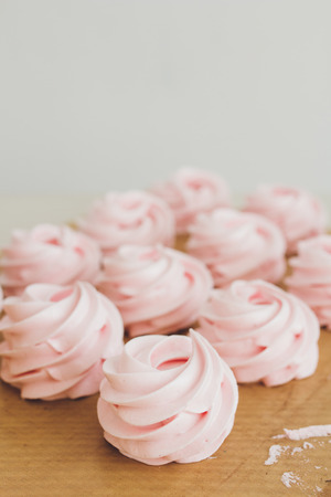 Delicate pink homemade marshmallows is on the table.  The concept of home cooking. Selective focus. Toning.の写真素材