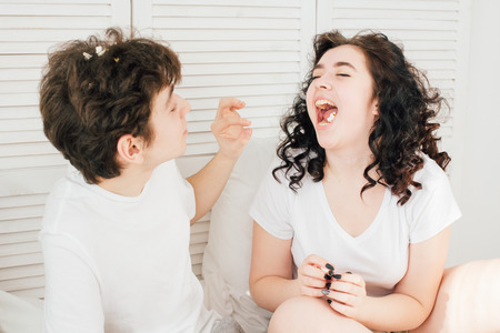 Loving couple having fun in bed and throwing popcorn. The concept of love and romance. Toning.の写真素材