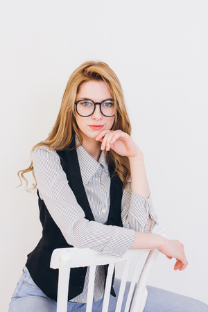 Young beautiful blonde girl posing in Studio on a white background. Toning.の写真素材