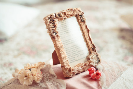 Delicate composition with photo frame decorated in rustic style. Selective focus. Vintage toning.