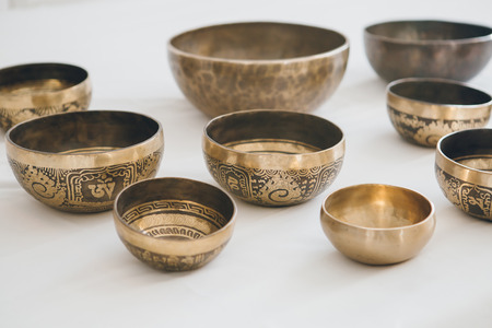 Tibetan singing bowls on white background in Spa. The concept of relaxation and alternative medicine. Selective focus. Toning.の写真素材