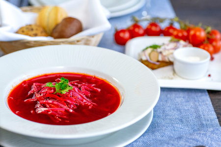 Beetroot soup, borscht, beautifully served in a white plate on the table in the restaurant. National...