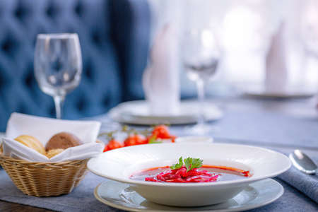 Beetroot soup, borscht, beautifully served in a white plate on the table in the restaurant. National Russian, Ukrainian cuisine. Restaurant menuの写真素材