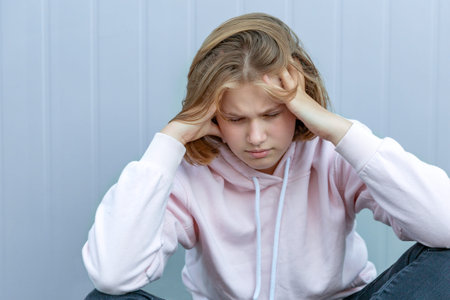 The teenage girl clutched her head in her hands, closing her eyes. The life and health of...