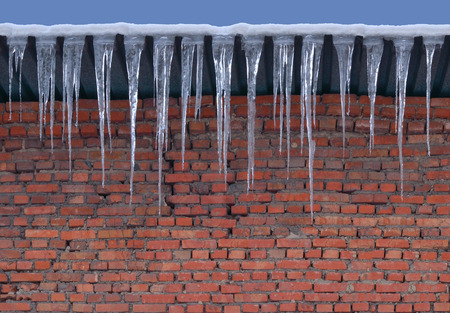 Brick wall rough masonry and large icicles.の写真素材