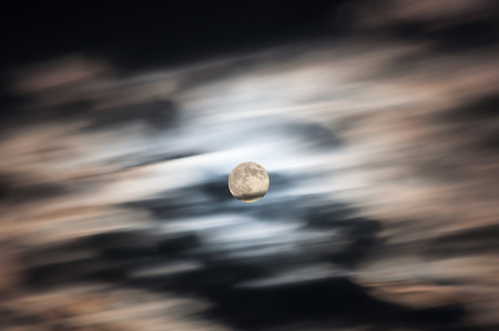 Abstract heavenly background of clouds and the moon shot on a long exposure sunsetの写真素材