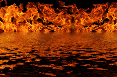 The flames from the fire on a black background with reflection in waterの写真素材