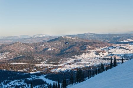 Top view of the ski slopes, mountains, the valley and the village belowの写真素材