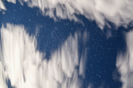 Beautiful abstract heavenly background with blurred clouds in the form of nebulae and stars in the form of tracks taken with a long exposureの写真素材