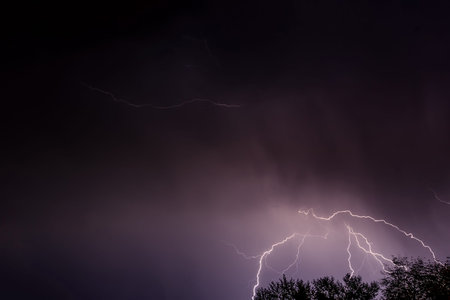 Beautiful natural background with a flash of lightning in dark blue clouds during thunderstorms
