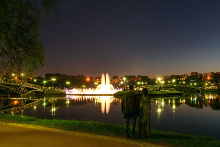 Park Tsaritsino, Moscow, Russia. Evening rest, May 19, 2019. People look at the beautiful color illuminated singing fountain against the background of the night skyのeditorial素材