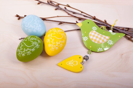 Easter eggs decorations on wooden table over retro background