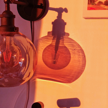 Photo of  shadows of the bulb lamp on the wall.の写真素材