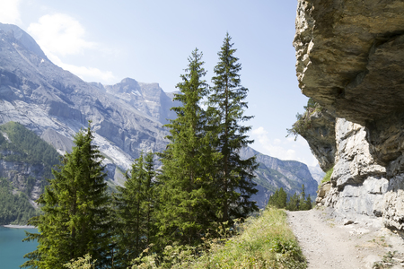 Amazing tourquise Oeschinnensee with waterfalls and Swiss Alps, Kandersteg, Berner Oberland, Switzerland.の写真素材