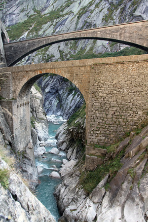 Modern bridge and a tunnel at the Devil's bridge at St.Gotthard, Switzerlandの写真素材