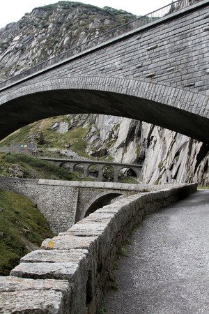 Modern bridge and a tunnel at the Devil's bridge at St.Gotthard, Switzerlandの写真素材