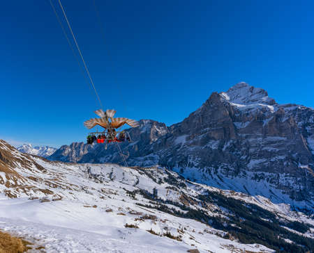 Flying with a bird of prey, an eagle called First Glider takes flight,  his four passengers float through the mountain landscape and enjoy a panoramic view at high speedsの写真素材