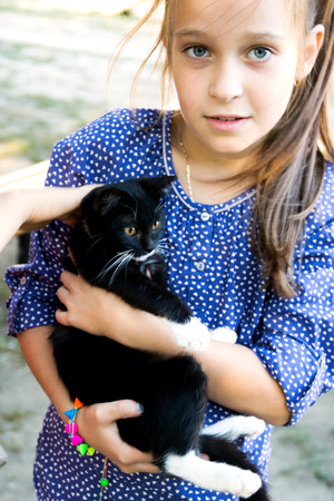 small girl with a small  black catの写真素材