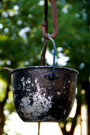 a huge, old, rusty cauldron in the meadowの写真素材