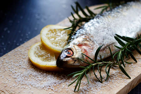 salted Sea Danube herring with rosemary sprigs, lemon and coarse sea salt. Photo. foodの写真素材