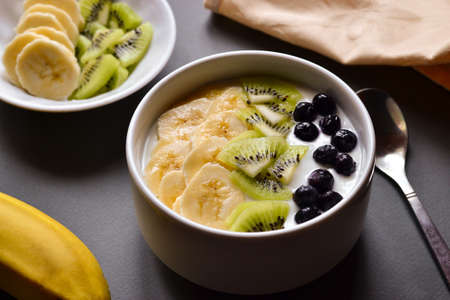 Healthy breakfast. Yogurt, cereal, banana, kiwi.の写真素材