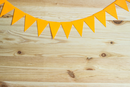 Garland of colorful flags on the background of natural wood.の写真素材