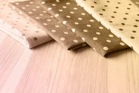 Linen napkins on a wooden table. The concept of table setting in country style. Images in sepia colors.の写真素材