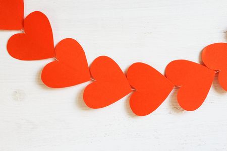 Red hearts on a light wooden background.の写真素材