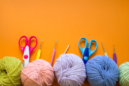 Colorful balls of yarn on an orange background. Colorful background. Copy space. Materials for knitting.の写真素材