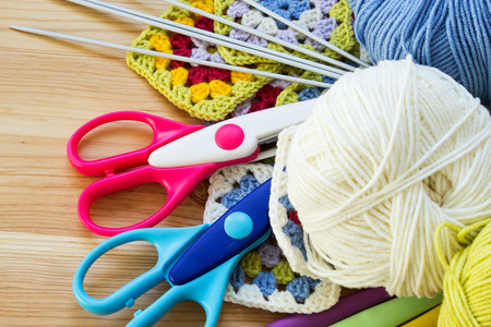 Concept of a woman's hobby. Knitting and work at home. Knitting.
Multicolored balls of yarn, scissors, knitting needles, hooks. Materials for creativity and crafts. Copy space.の写真素材