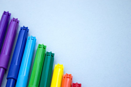 Colorful markers on a blue background. Multicolored markers with space for text.