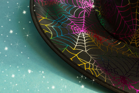 Magic hat on a blue background. Halloween background. Traditional decoration for a scary holiday. Copy space. Flat layout.の写真素材