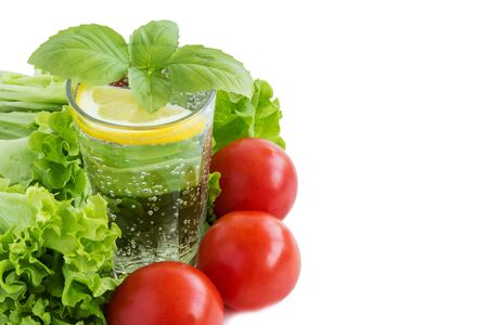 Clean water, salad, tape measure and cutlery on a white background. The concept of healthy eating and losing weight. Sports nutrition.の写真素材